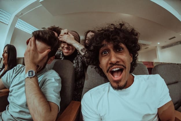 A diverse group of young adults laughing joyfully while watching a movie in a modern, comfortable movie theater with reclining seats and gourmet snacks.