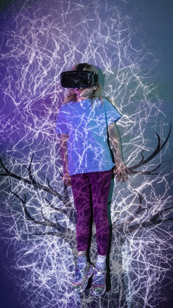 A person wearing a VR headset experiencing an immersive digital environment, with abstract digital elements swirling around them.
