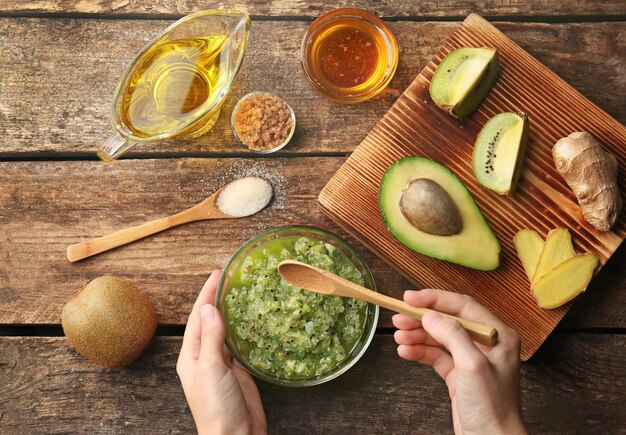 A close-up of a person applying a homemade facial mask, with a bowl of natural ingredients like avocado and honey nearby, highlighting affordable skincare.